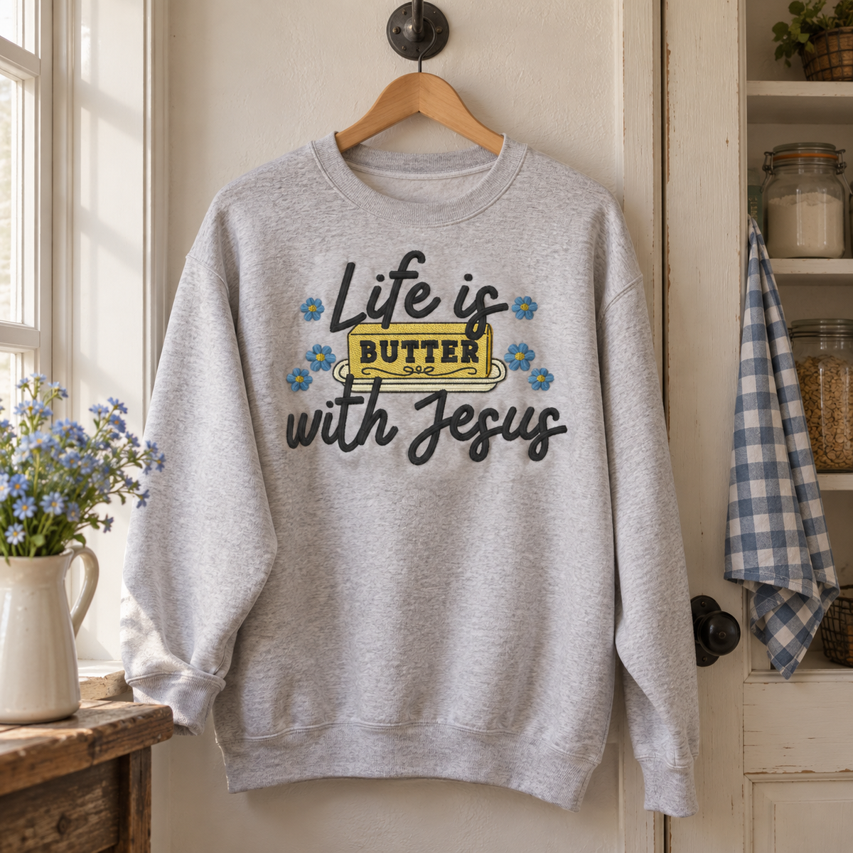 Ash Life Is Butter With Jesus sweatshirt hanging naturally in a farmhouse pantry