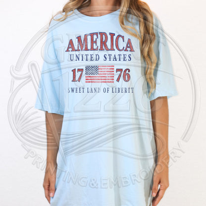 Light blue America 1776 patriotic t-shirt with vintage USA flag graphic for women