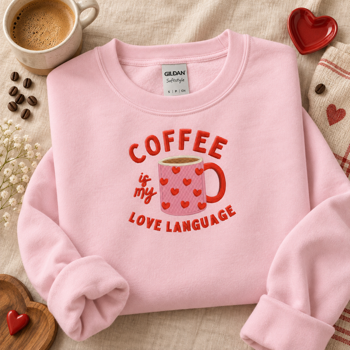 Light Pink Gildan coffee love language embroidered sweatshirt flat lay