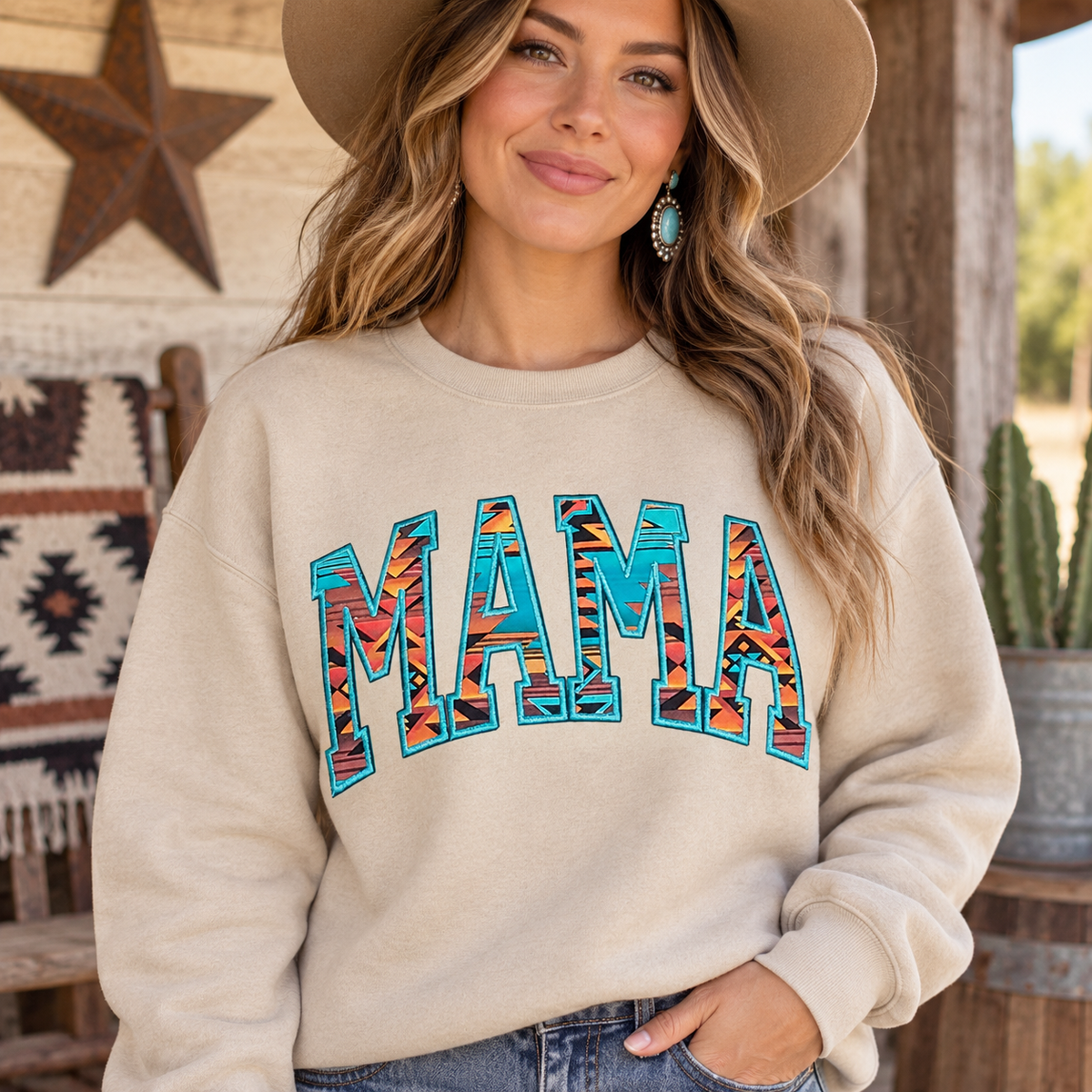 Woman wearing Sand MAMA Aztec appliqué crewneck sweatshirt on a rustic western porch