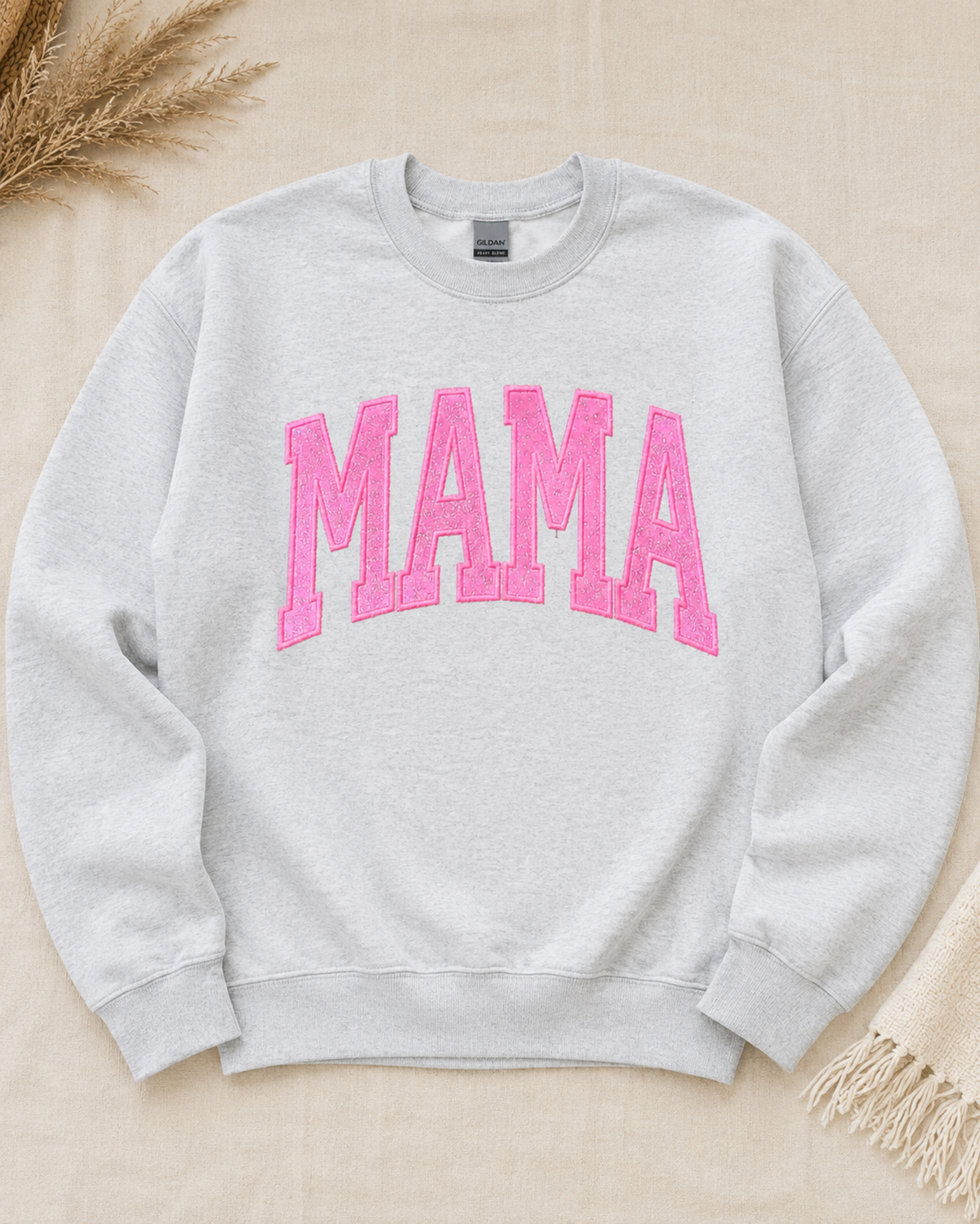 Ash Gildan Heavy Blend MAMA sweatshirt with hot pink glitter vinyl appliqué flat lay