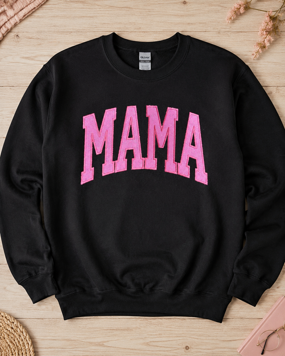 Black Gildan Heavy Blend MAMA sweatshirt with hot pink glitter vinyl appliqué flat lay