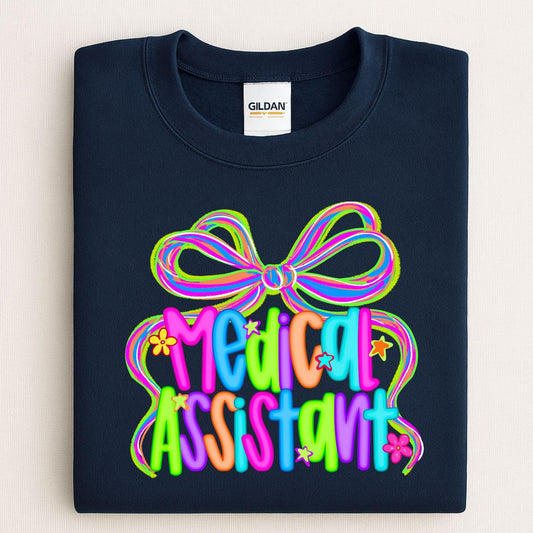 Navy sweatshirt with a colorful neon Medical Assistant bow graphic folded flat