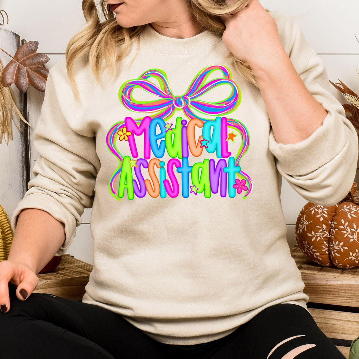 Sand sweatshirt modeled with a colorful Medical Assistant bow design