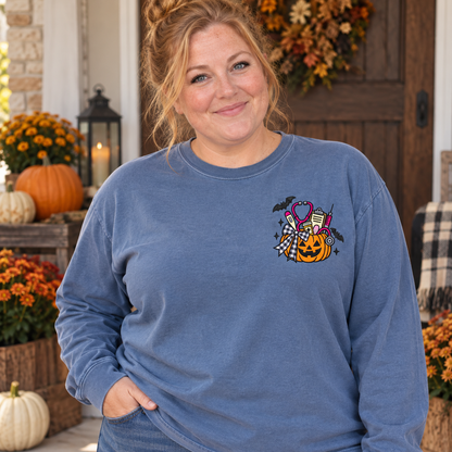 Adult woman wearing a Blue Jean long sleeve shirt with medical pumpkin embroidery on the left chest