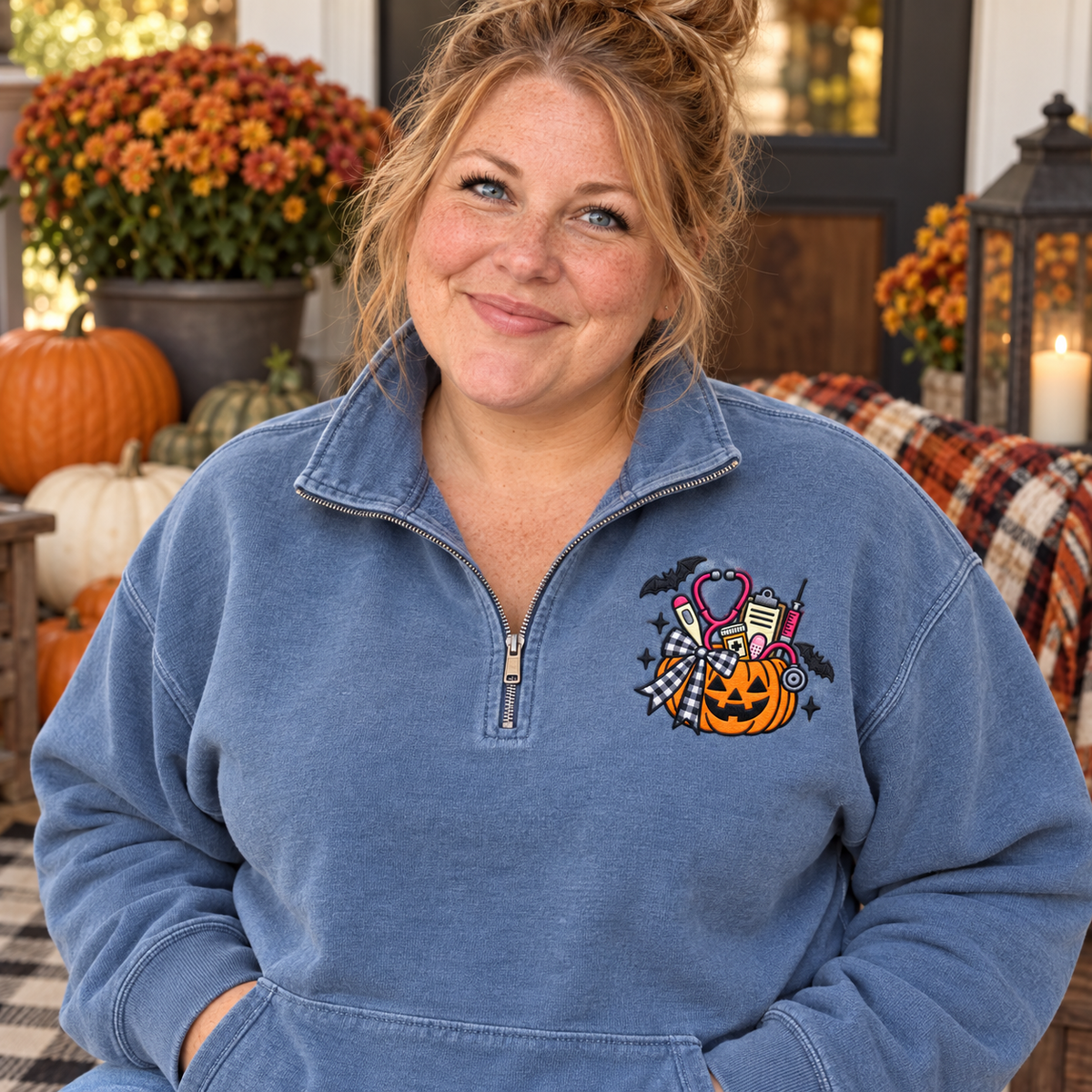 Adult woman wearing a Blue Jean quarter-zip with medical pumpkin embroidery on the left chest