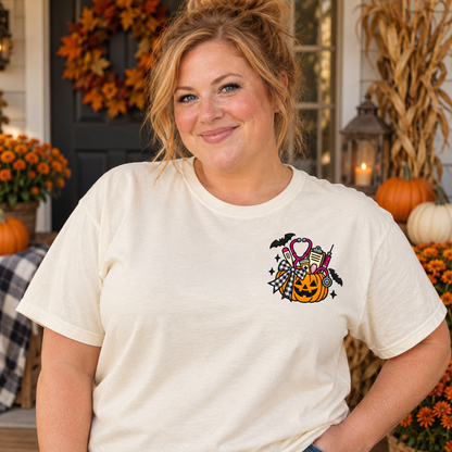 Adult woman wearing an ivory short sleeve T-shirt with medical pumpkin embroidery on the left chest