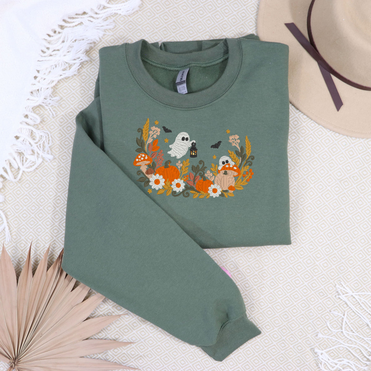 Military Green floral ghost and pumpkin embroidered sweatshirt cozy flat lay