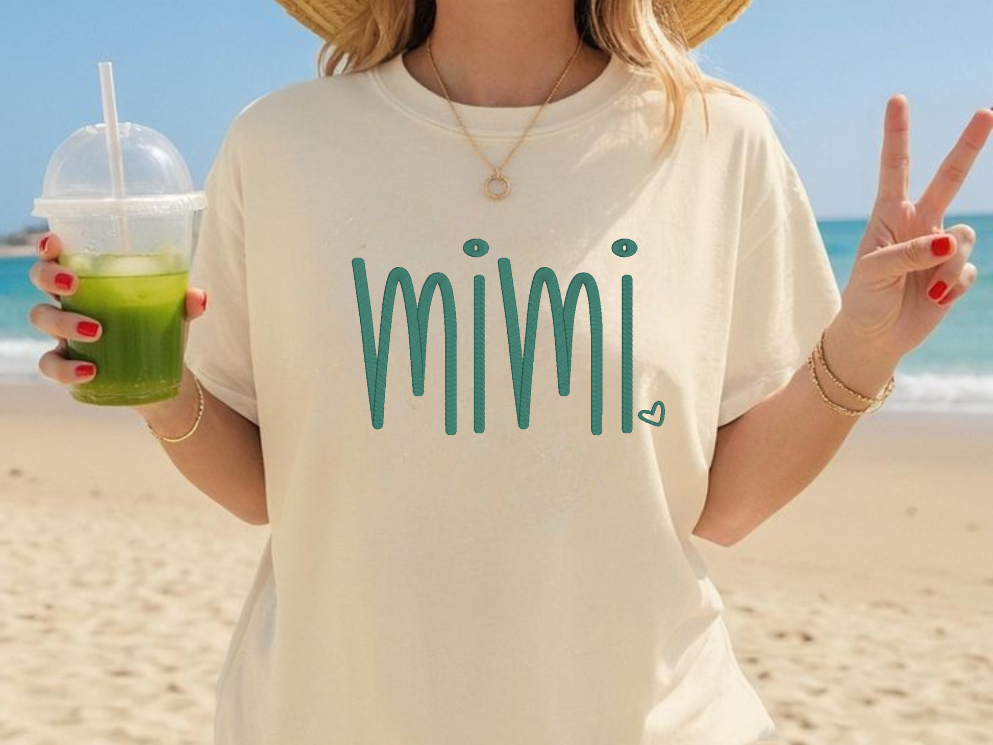 Person wearing a 'mimi' shirt on a beach
