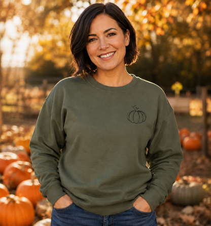Military Green Gildan Softstyle sweatshirt with small black pumpkin embroidery at a fall pumpkin patch