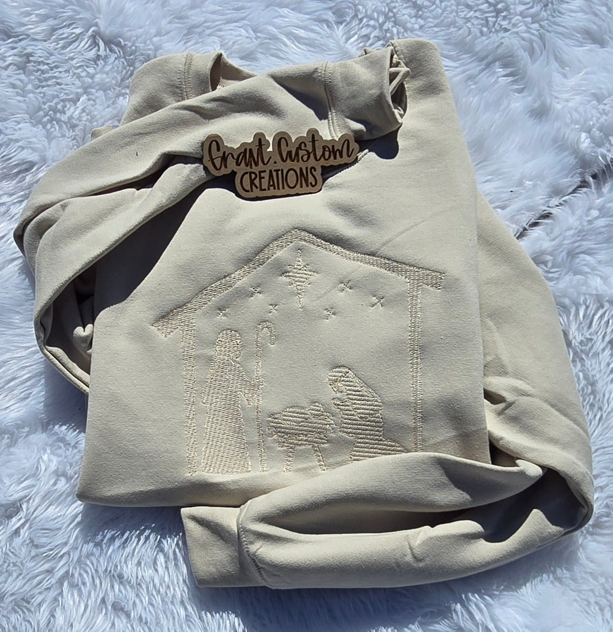 Real tone-on-tone Minimalist Nativity embroidery on Sand crewneck sweatshirt