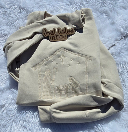 Real tone-on-tone Minimalist Nativity embroidery on Sand crewneck sweatshirt