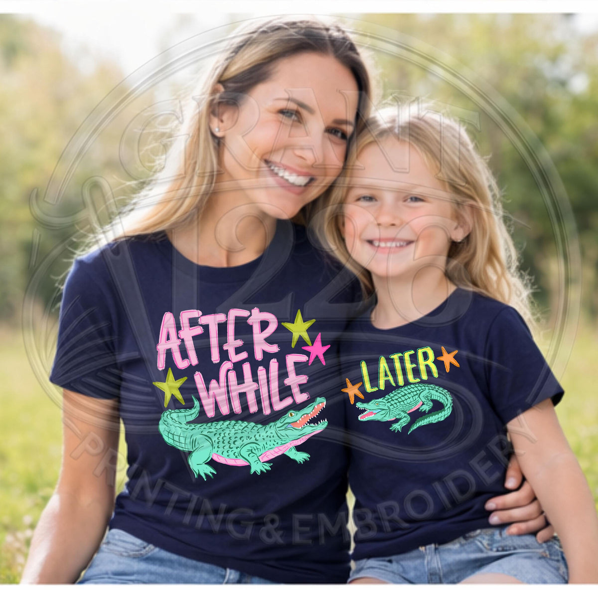 Mom and daughter wearing navy matching alligator shirts outdoors