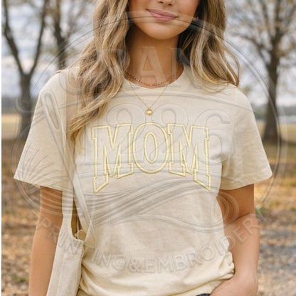 Woman wearing cream embroidered MOM Comfort Colors shirt outdoors
