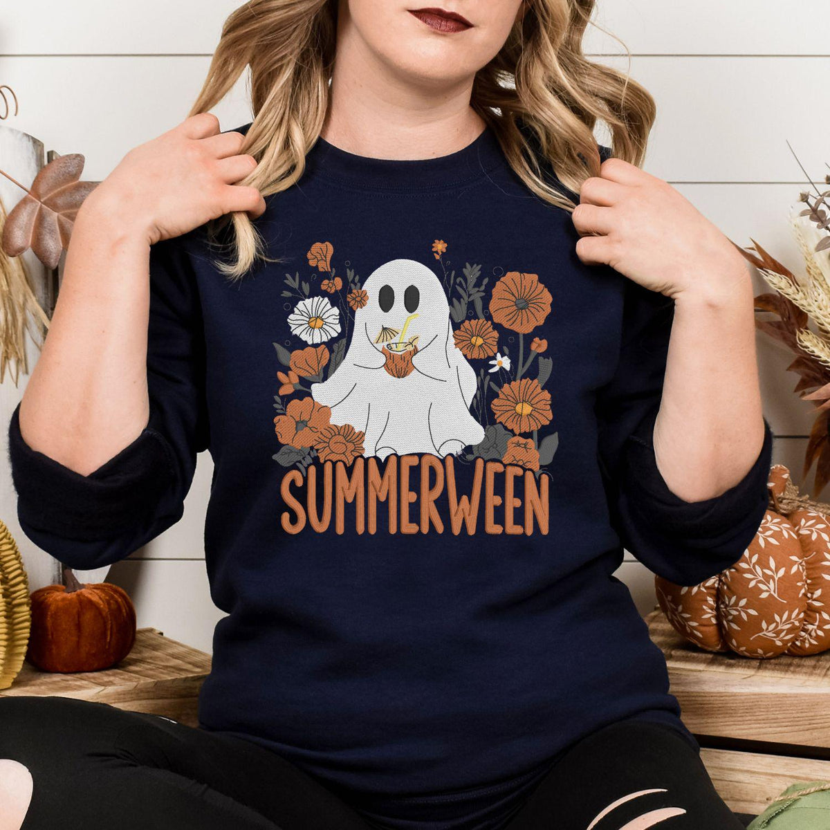 Navy floral ghost Halloween embroidered crewneck shown with a white pumpkin