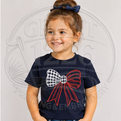 Child wearing Navy embroidered red, white, and blue gingham bow shirt