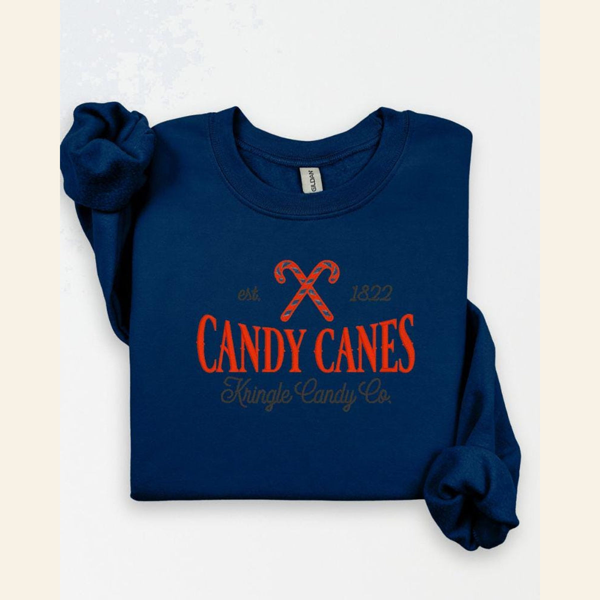 Navy Kringle Candy Co candy cane holiday embroidered crewneck flat lay