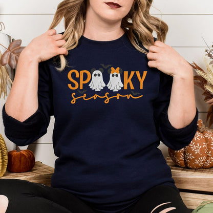 Navy Spooky Season embroidered sweatshirt with two bow-wearing ghosts, model view