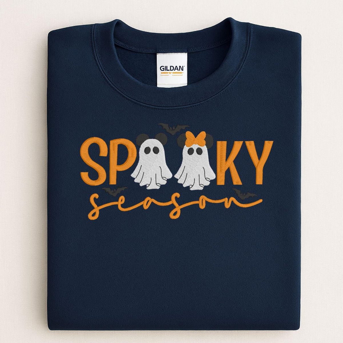 Folded Navy sweatshirt with embroidered Spooky Season ghosts and bows design