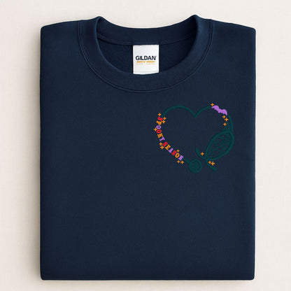 Folded Navy sweatshirt with Spooky Season stethoscope heart embroidery