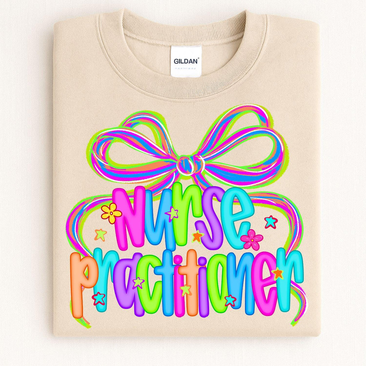 Folded sand crewneck with colorful Nurse Practitioner bow design