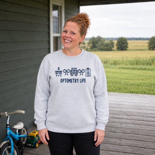 Samantha wearing an Ash Gildan sweatshirt with blue Optometry Life embroidery