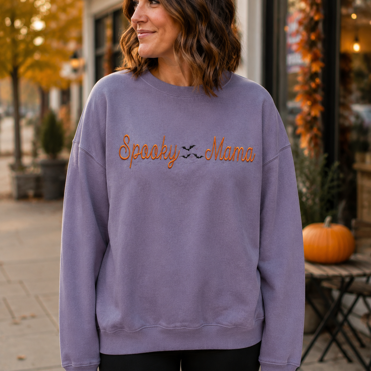 Paragon Spooky Mama embroidered Halloween sweatshirt lifestyle mockup outside a coffee shop