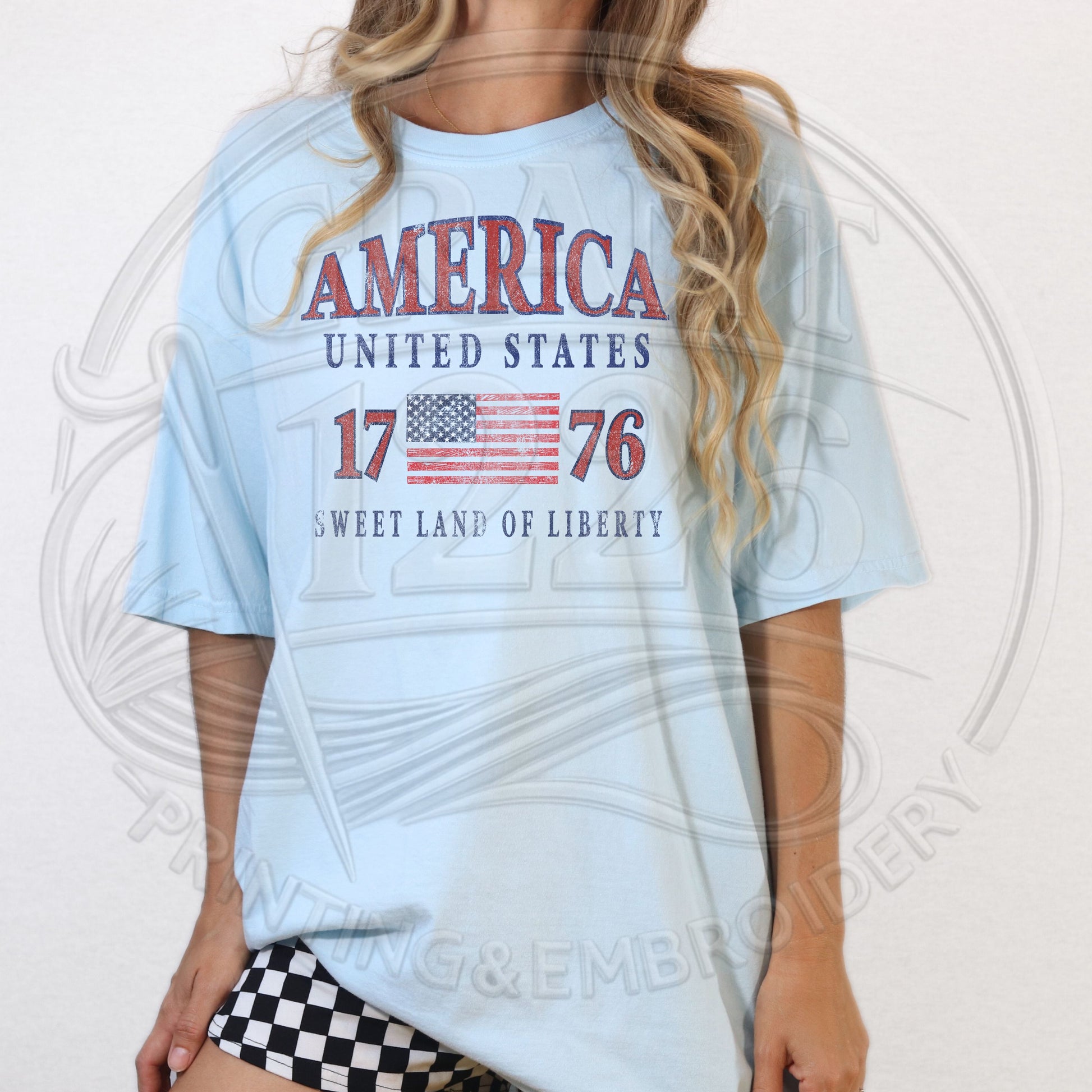Pastel blue vintage America 1776 patriotic shirt for women with distressed flag graphic