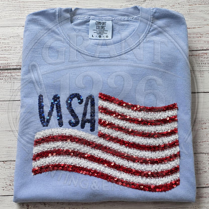 Styled patriotic shirt flat lay with Americana accessories for Fourth of July outfit inspiration.