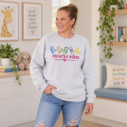 Woman wearing ash pediatric nurse dinosaur embroidered sweatshirt