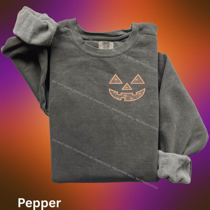 Pepper Comfort Colors sweatshirt with orange geometric jack-o-lantern embroidery flat lay