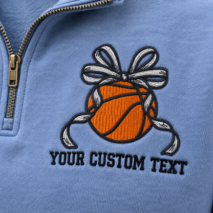Close-up of basketball bow and custom text embroidered on a Blue Jean quarter zip