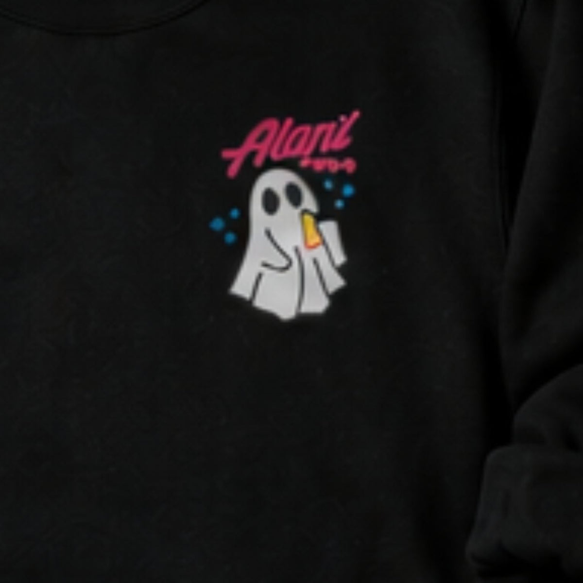Close-up of personalized name and ghost pocket embroidery on a black sweatshirt