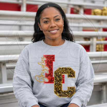 Model wearing a sport grey personalized sequin letter sweatshirt at bleachers for a school spirit look.
