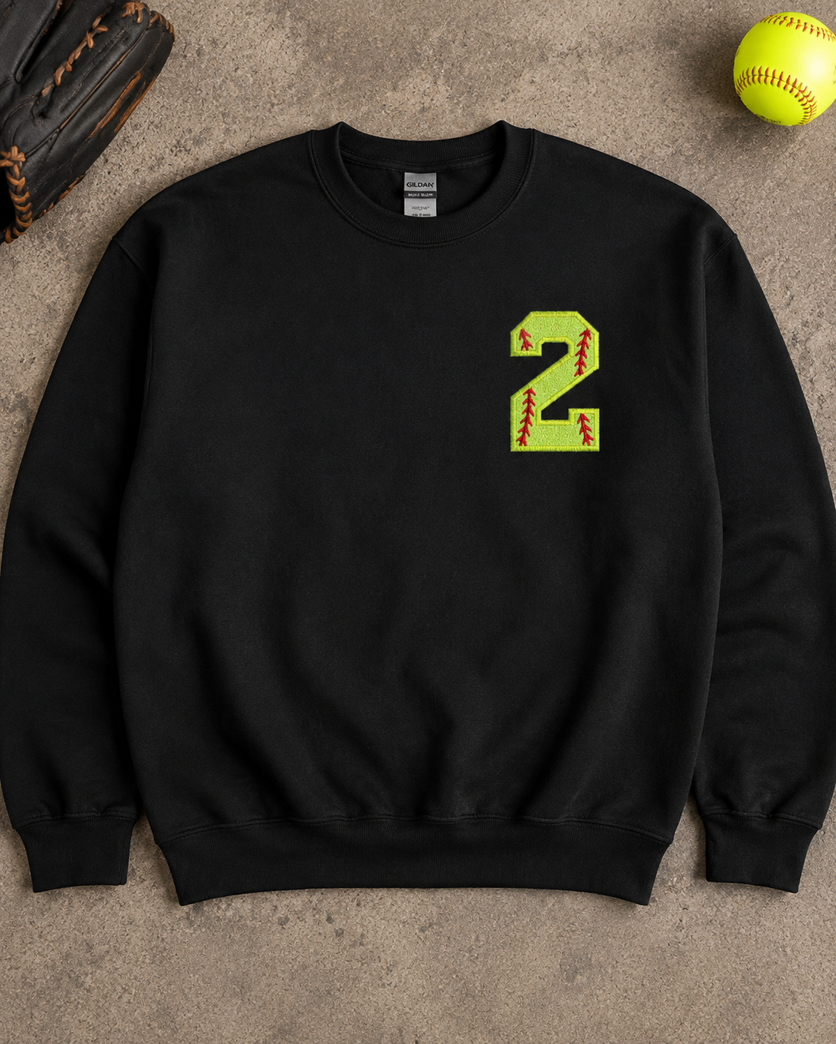 Black personalized softball number 2 appliqué sweatshirt flat lay with softball accessories