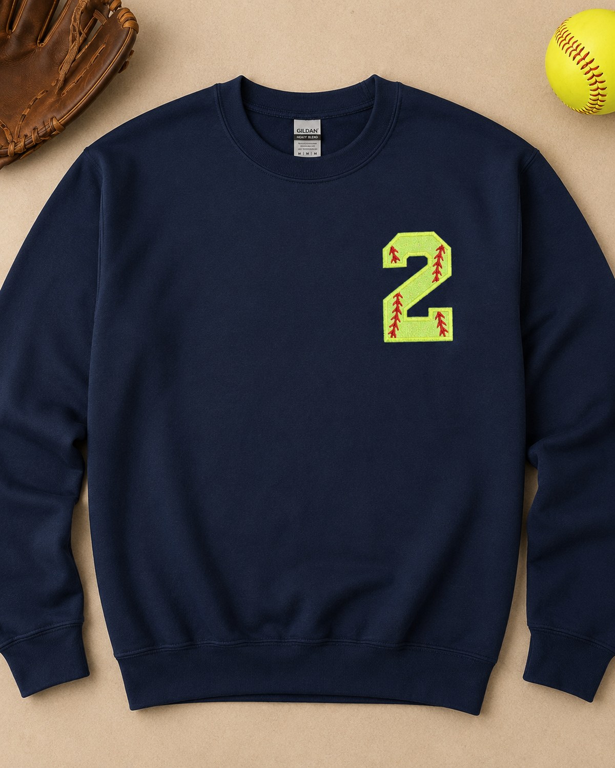Navy personalized softball number 2 appliqué sweatshirt flat lay with softball accessories