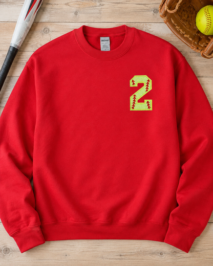 Red personalized softball number 2 appliqué sweatshirt flat lay with softball accessories