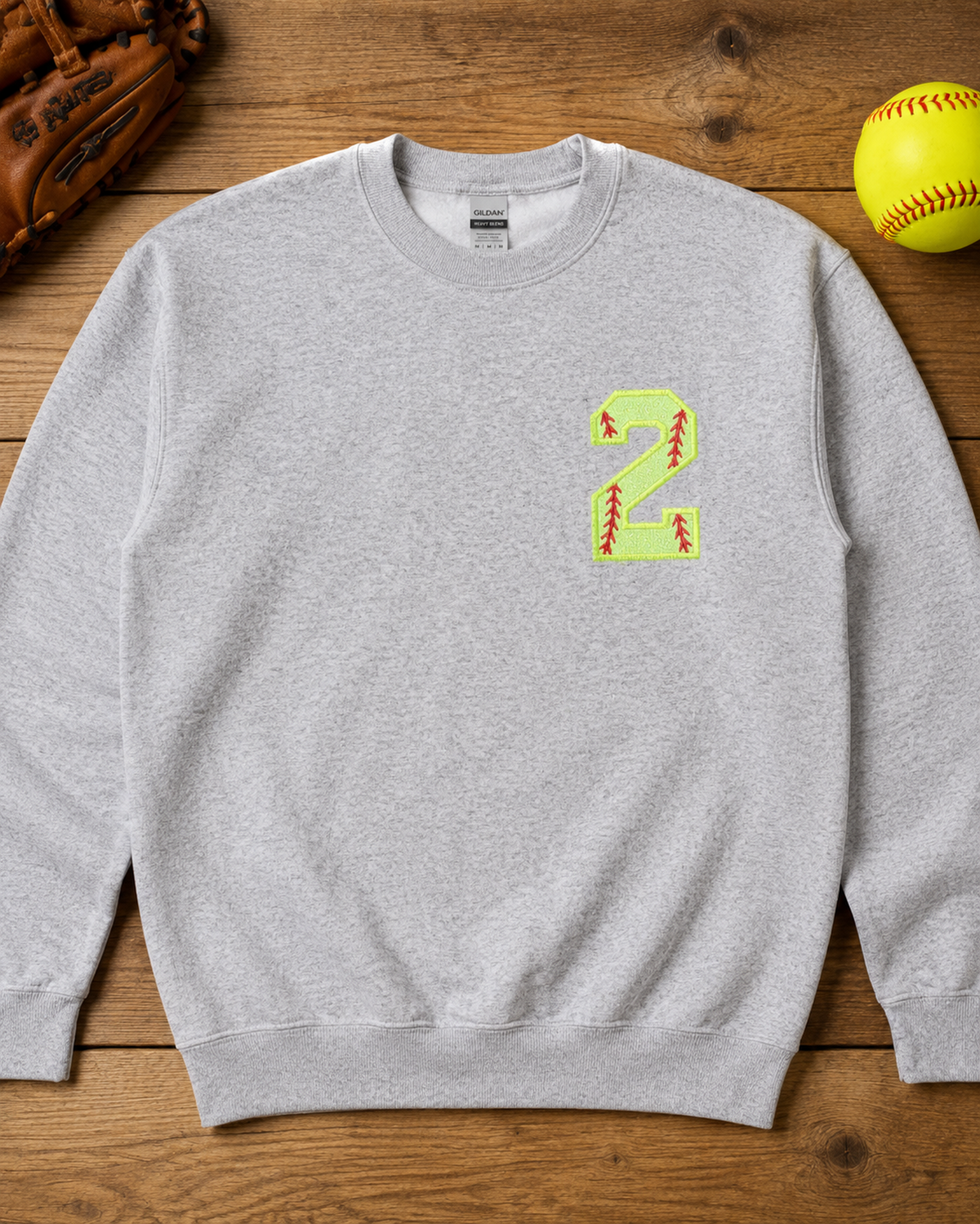 Sport Grey personalized softball number 2 appliqué sweatshirt flat lay with game day accessories