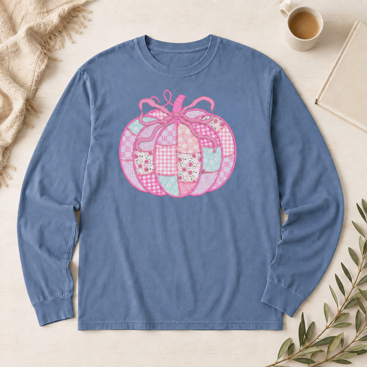 Blue Jean Comfort Colors 6014 long sleeve shirt with a pink patchwork bow pumpkin DTG design