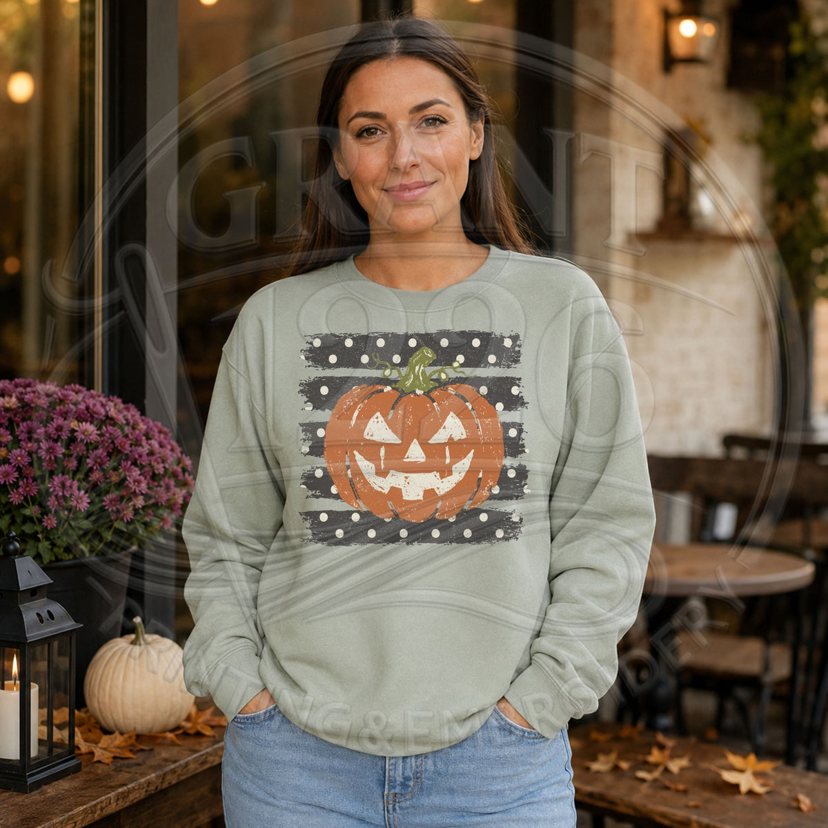 Woman wearing sage vintage jack o lantern Halloween sweatshirt with distressed pumpkin graphic