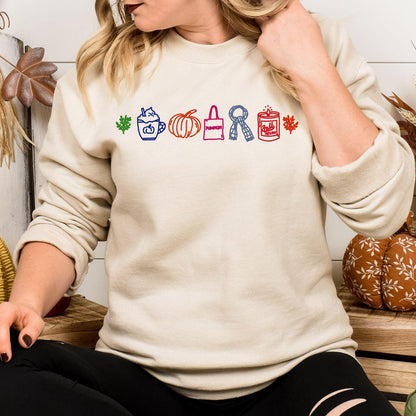 Sand sweatshirt with a colorful row of embroidered fall icons modeled indoors