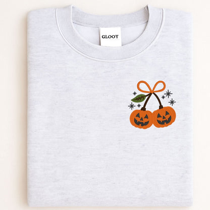 Folded Ash crewneck sweatshirt with orange pumpkin embroidery