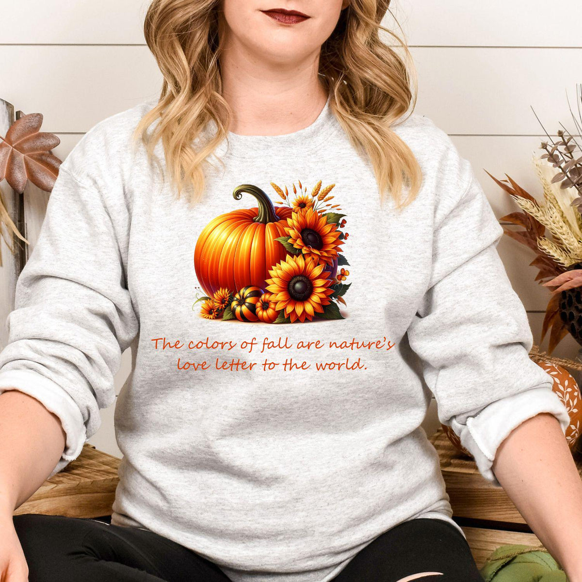Sport gray pumpkin and sunflower graphic sweatshirt modeled while seated