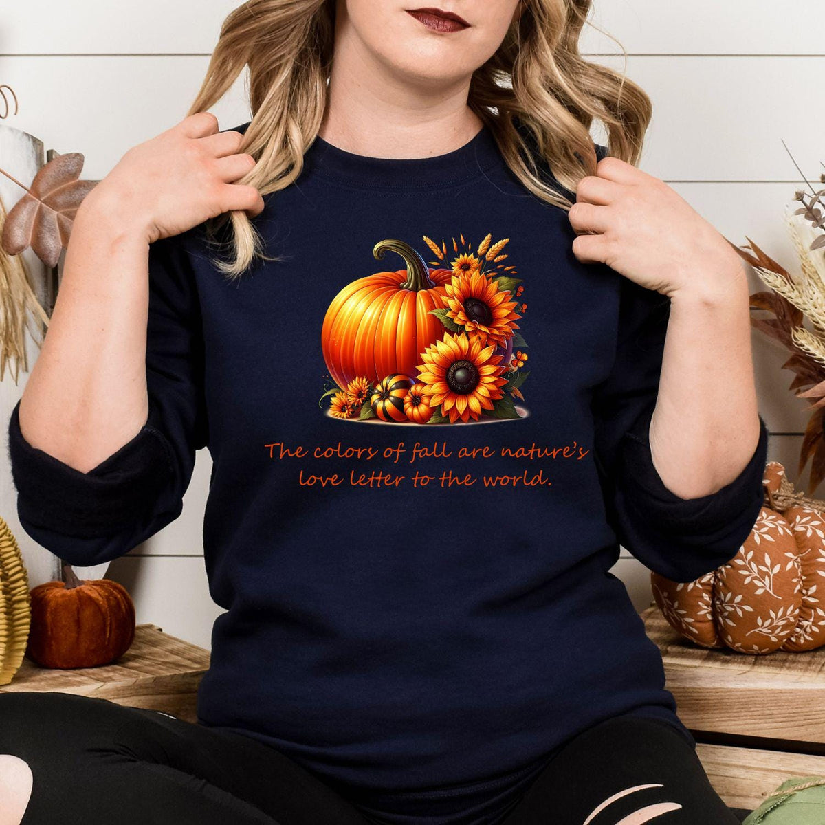 Navy fall pumpkin and sunflower sweatshirt modeled indoors