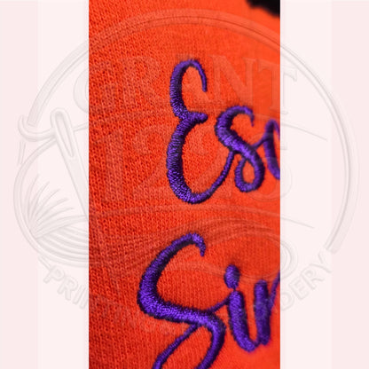 Close-up of purple embroidery on orange Escaped Since 1692 Halloween sweatshirt