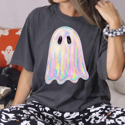 Woman seated in charcoal oversized T-shirt with rainbow pastel ghost graphic