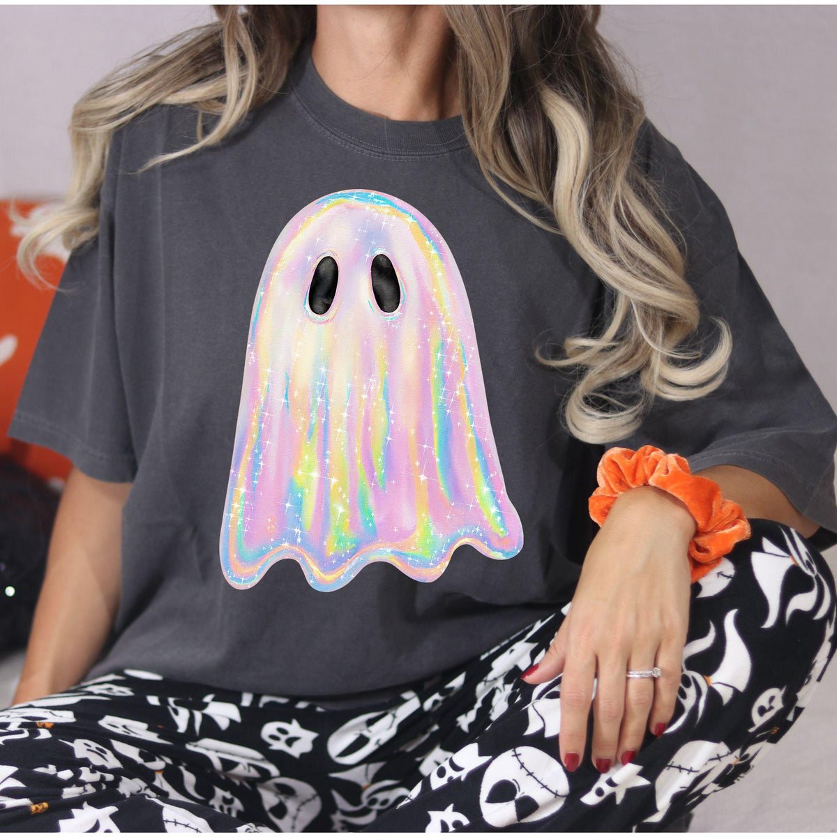 Close lifestyle view of charcoal rainbow ghost shirt with orange scrunchie