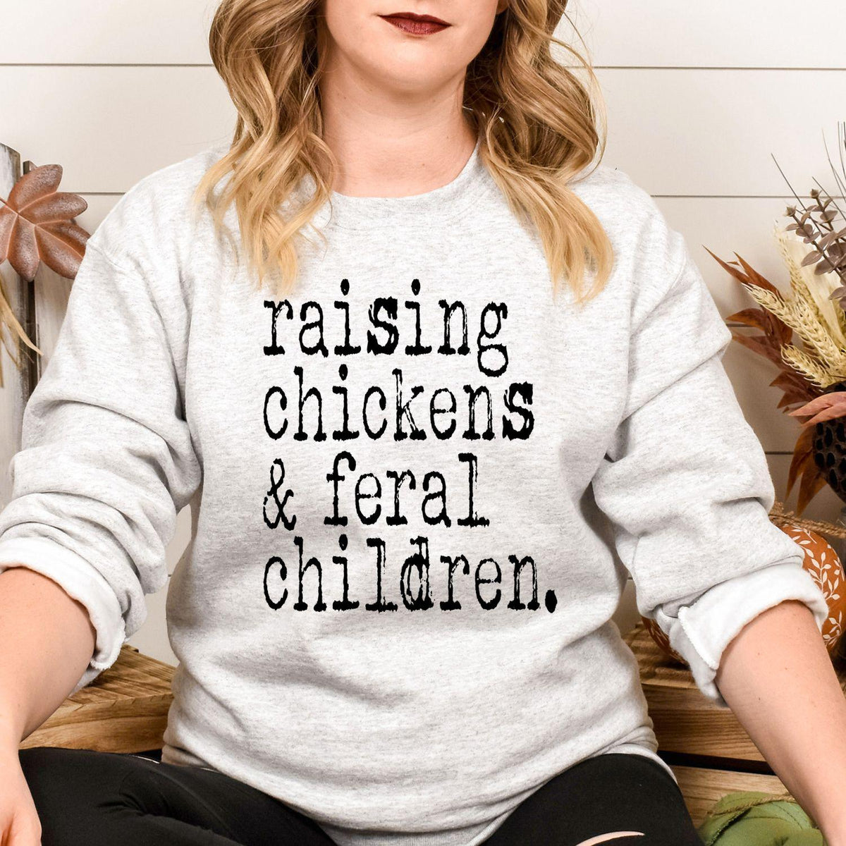 Model wearing ash gray Raising Chickens and Feral Children sweatshirt