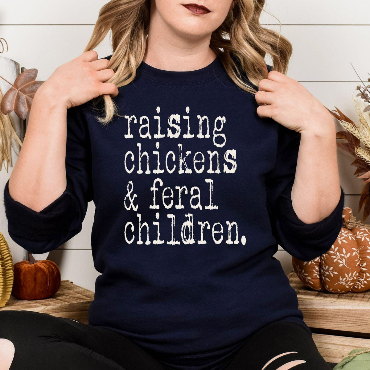 Front view of navy Raising Chickens and Feral Children crewneck