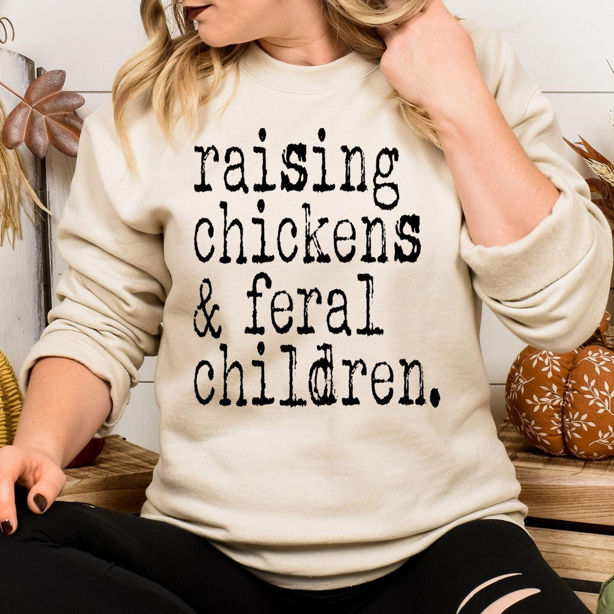 Model wearing sand Raising Chickens and Feral Children sweatshirt